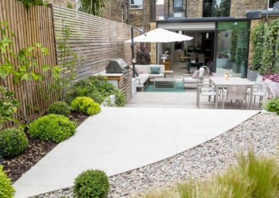 Back garden design in Friern Road, Dulwich, 10 Curvilinear patio with pebble surround and herbaceous border