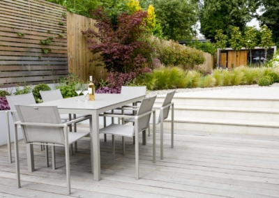Garden design in Friern Road, Dulwich, 2 Decked dining area with raised beds and porcelain steps to lawn