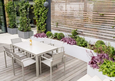 Back garden design in Friern Road, Dulwich, 8 Decked dining area framed by raised beds and screen fence
